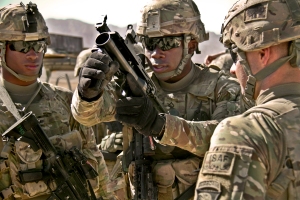 U.S. Army Pfc. Rohan Wright, center, a cavalry scout with a personal security detachment with the 4th Brigade Combat Team, 101st Airborne Division, prepares to fire an M203 grenade launcher at the weapons range at Forward Operating Base Thunder in Paktia province, Afghanistan, Oct. 18, 2013. U.S. Army photo by Sgt. Justin A. Moeller