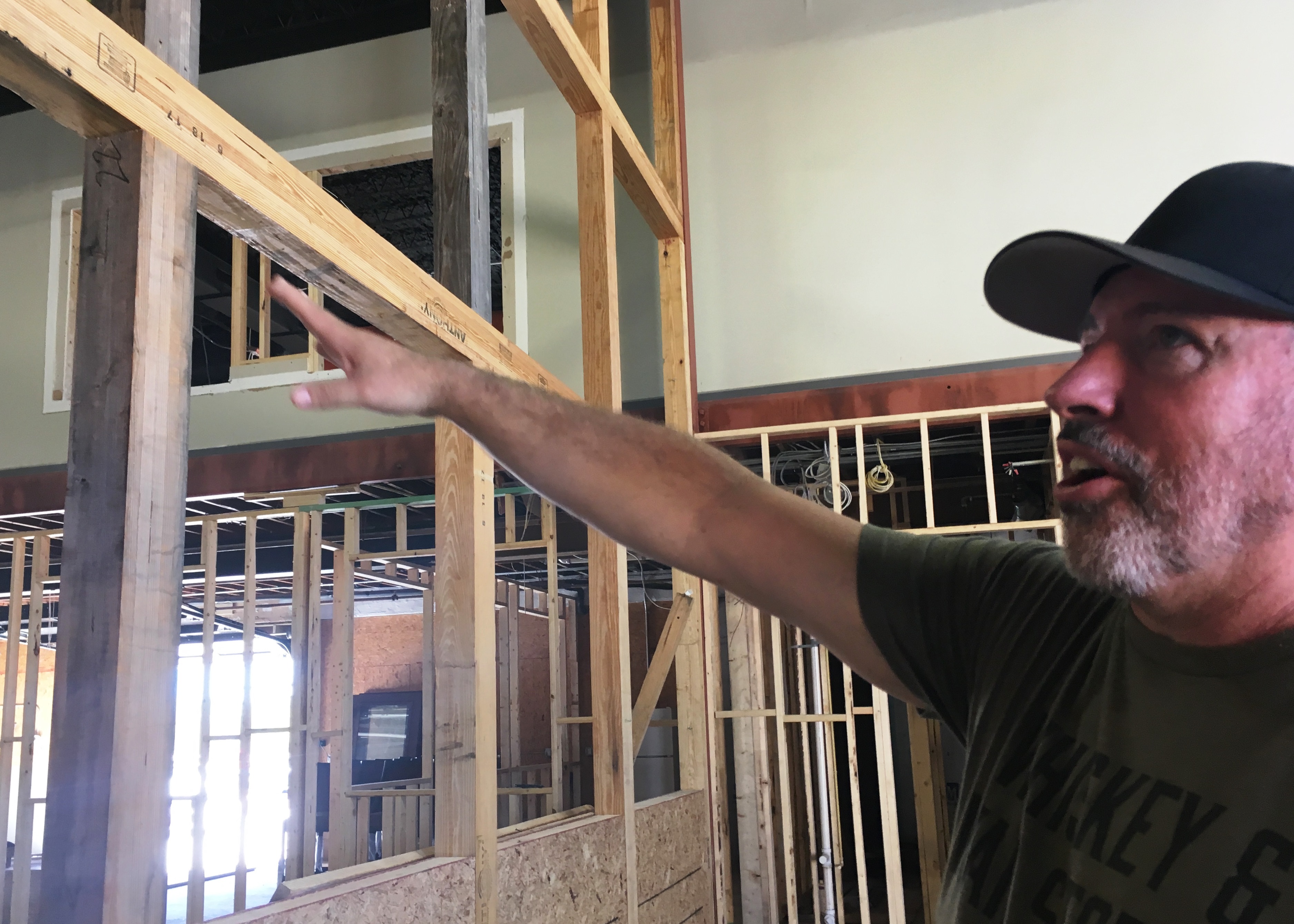 afd scott neil points to glass wall separating distillery from restaurant